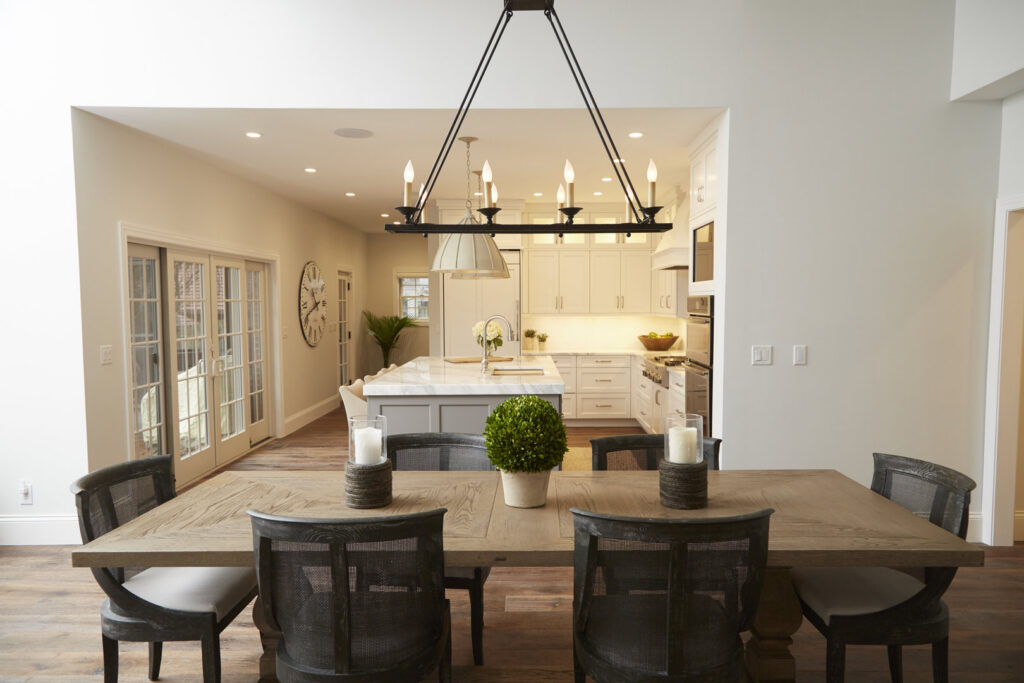 An open-concept dining room leading into a modern kitchen, a project by Creasey Construction of Illinois, Inc. in Springfield, IL