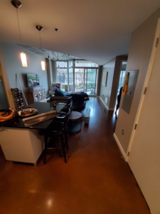 An open-concept living space featuring new flooring and a smooth transition to another area, completed by J & J Home Improvements, LLC in Franklin, TN.