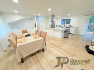 A newly remodeled open-concept living space featuring a dining area and modern kitchen by JP. Remodel Service LLC in Everett, WA.