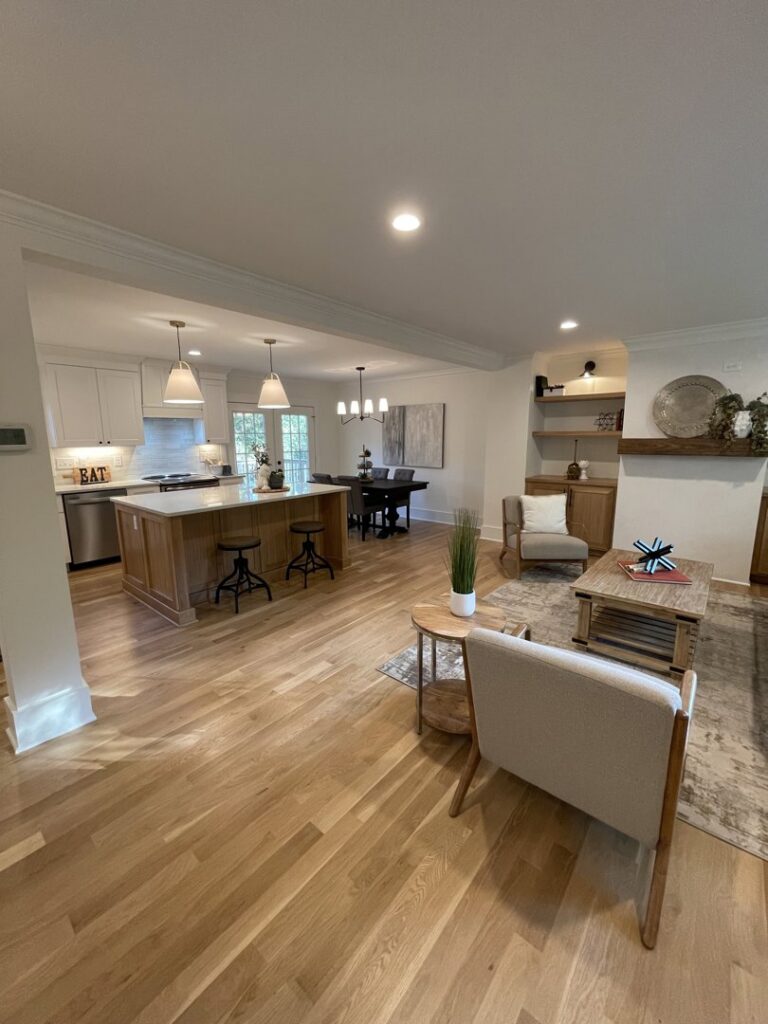A complete open-concept home renovation showcasing a modern kitchen, dining area, and living space by Pro Finishes NC, LLC in Raleigh, NC.