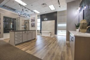 An open-concept kitchen with a large island, bar seating, and modern pendant lights by DFW Improved in Plano, TX.