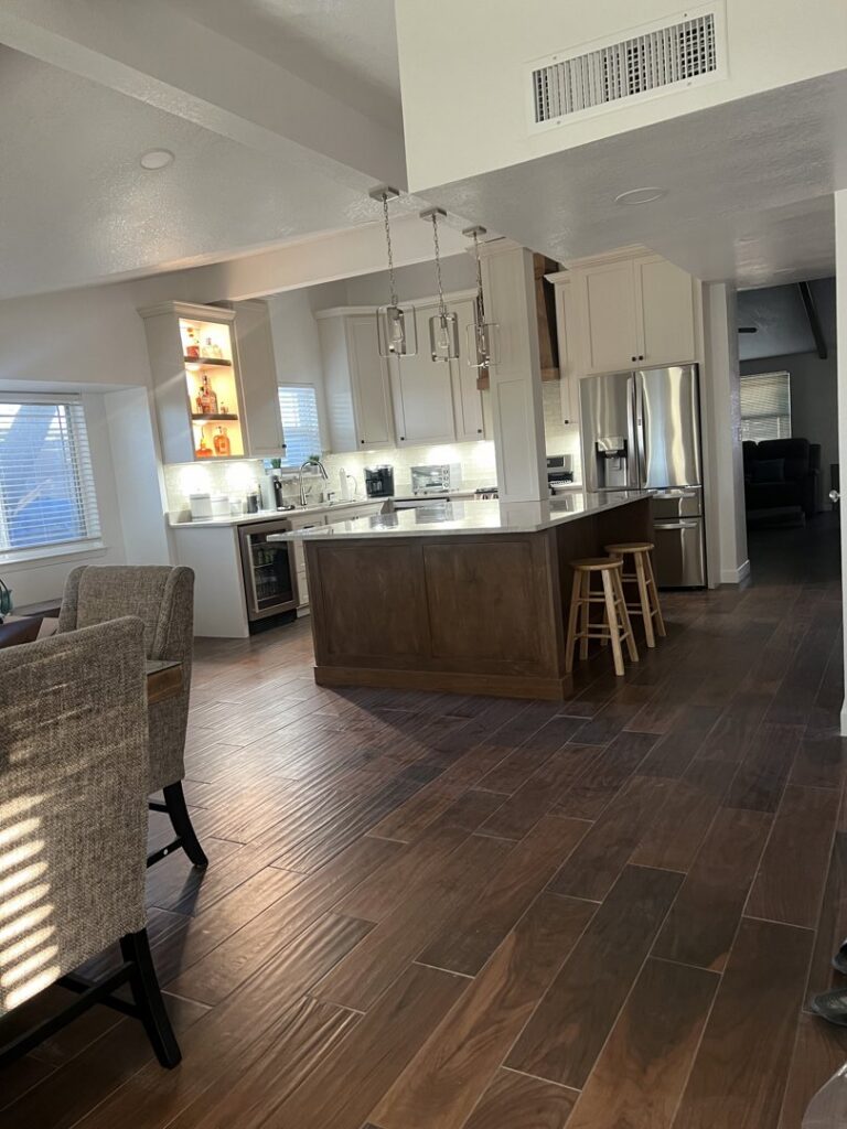 Open-concept kitchen and dining area remodel with a large island by APJ Construction Inc. in El Paso, TX.