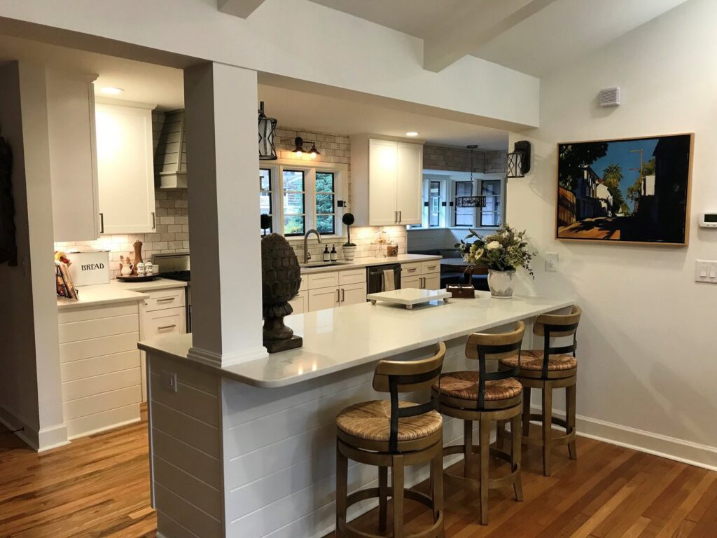 An open-concept kitchen with a spacious island and bar seating, expertly crafted by Technically Aesthetic General Contractors in Johnson City, TN.