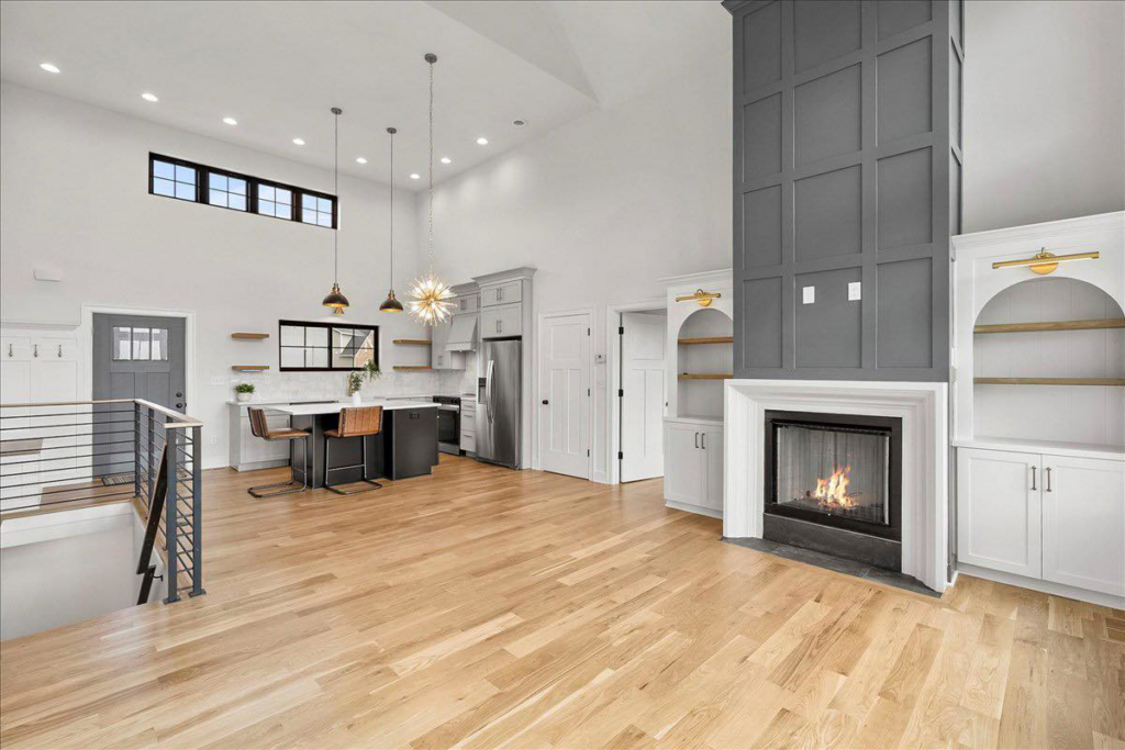 Open concept kitchen and living area with beautiful hardwood floors by WoodHaven Floor Refinishing in Georgetown, KY.