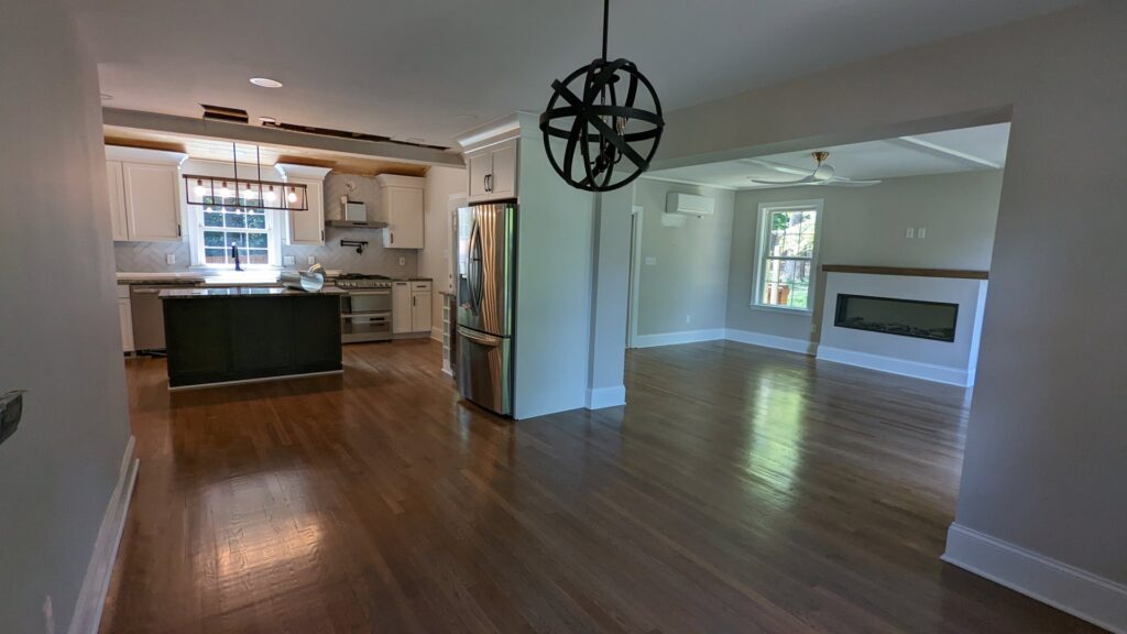 An open-concept kitchen and living room with newly painted walls and modern finishes by Global Painting RVA in Richmond, VA.