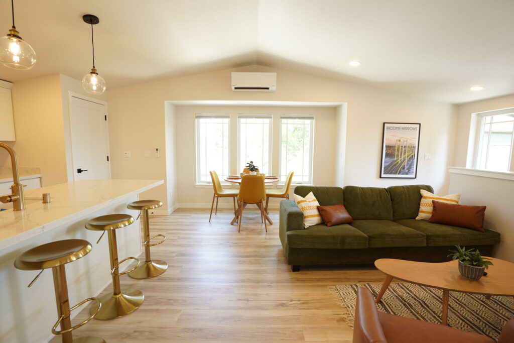 An open-concept living area with a renovated kitchen and dining space by Gordon T. Jacob in Tacoma, WA