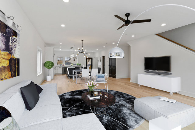 An open concept living and dining area with light wood floors and modern decor by Inland Home Remodeling Inc. in Chicago, IL.