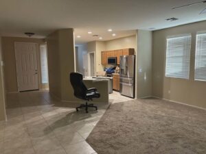 An open-concept living and kitchen area with light wood cabinets, showing interior remodeling by Desert Remodel in Scottsdale, AZ.