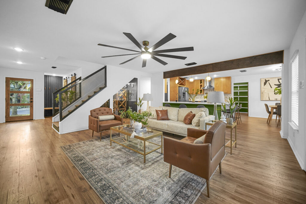 An open-concept living room and kitchen area with modern finishes, completed by HomeNovate in San Antonio, TX.