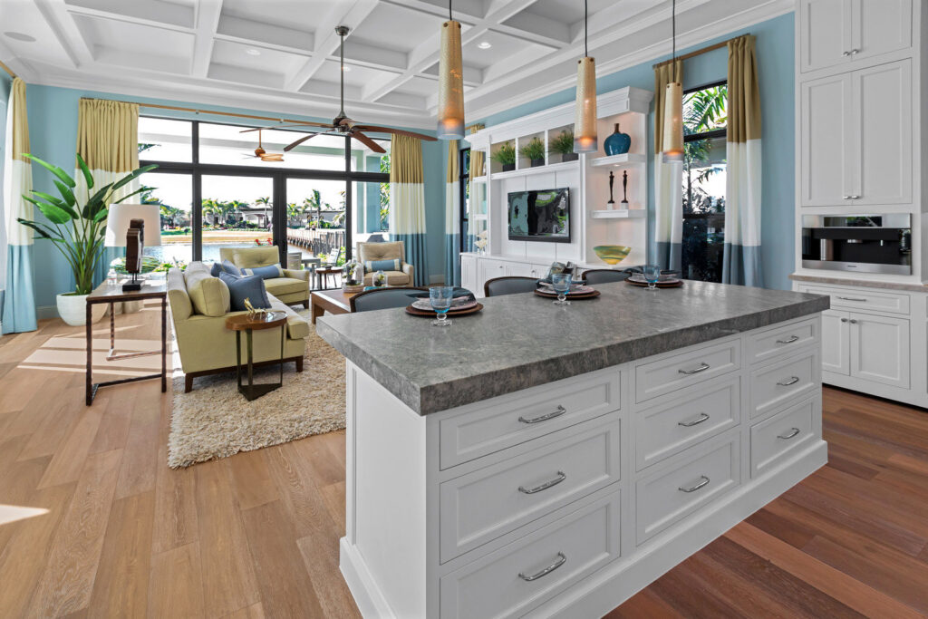 An open-concept living and kitchen area remodel with coffered ceilings by Kornerstone Kitchens in Orlando, FL.