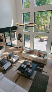 An open-concept living room with high ceilings and large windows, built by DJK Custom Homes in Naperville, IL