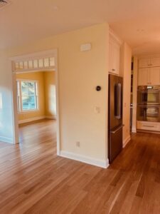 An open concept living space featuring new hardwood flooring and trim work completed by R&J Handyman Services LLC in Warwick, RI.