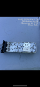 An open fiber optic splice enclosure on a work surface, demonstrating infrastructure work by KPL Fiber Solutions LLC in Houston, TX.