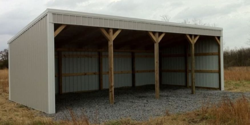 An open-sided metal shed with wooden support beams, built by D.H. Construction in Jackson, TN.