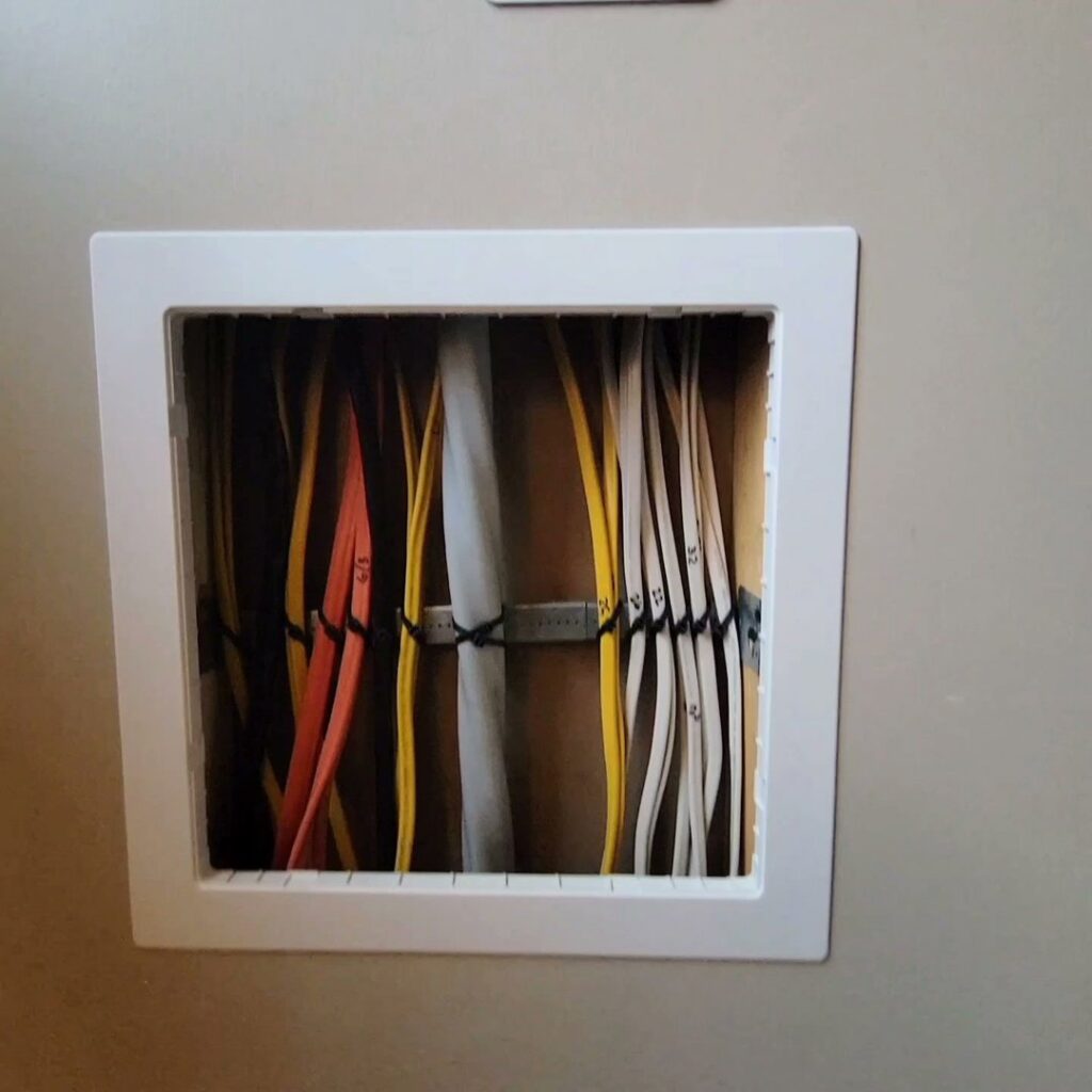 Neatly organized electrical wiring in a wall cavity, showcasing professional installation by MorLite Electric in Newport News, VA.
