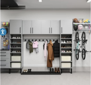 An organized garage featuring grey storage cabinets, shelving, and a wall-mounted bike rack by Bend Garage Storage Solutions in Bend, OR