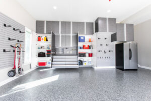 A fully organized garage featuring custom cabinets, slatwall, and epoxy flooring by PremierGarage of Baltimore in Baltimore, MD.