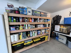 Organized garage shelving unit with cleaning supplies installed by Home Pros WV in Charleston, WV.
