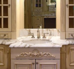 Ornate bathroom vanity with a marble countertop and sink installed by Art of Stone Shop in Bridgeport, CT.