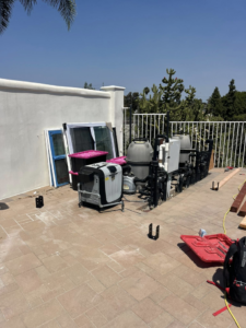 An outdoor area with pool equipment, showing the site for a construction project by Pauda Handyman in San Diego, CA.