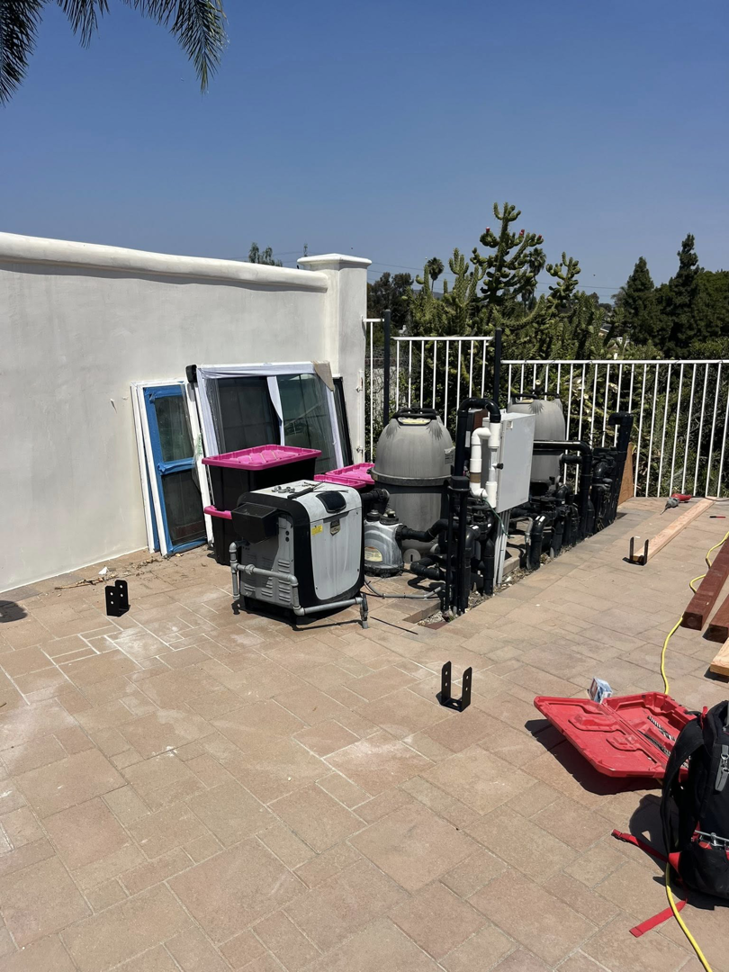 An outdoor area with pool equipment, showing the site for a construction project by Pauda Handyman in San Diego, CA.
