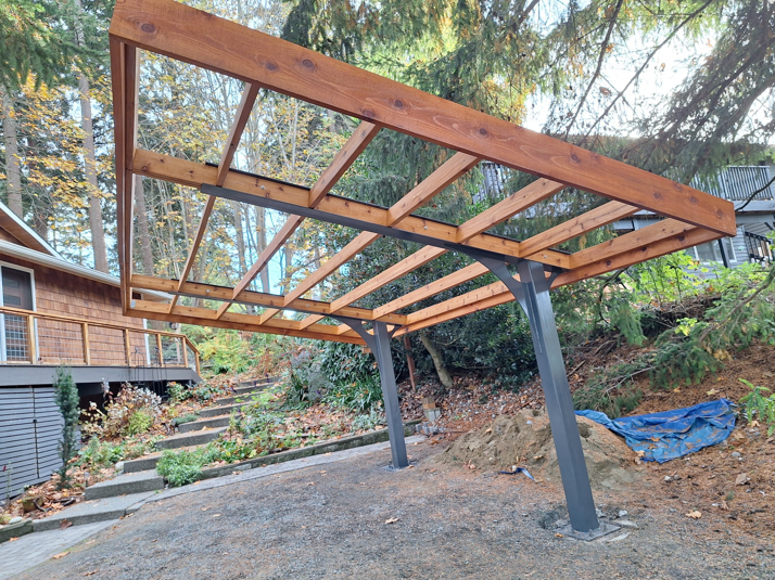 Framework of an outdoor carport or pergola under construction by Eagle Outdoor Living LLC in Freeland, WA.