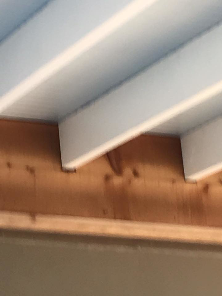 Outdoor ceiling construction with wooden beams and white planks by Felipe Garcia Remodeling and Construction in Mobile, AL.