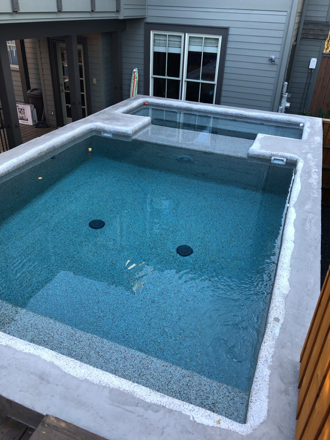 An outdoor concrete pool and spa under construction, showcasing general contractor work by Kaleidoscope Design Build in Houston, TX.