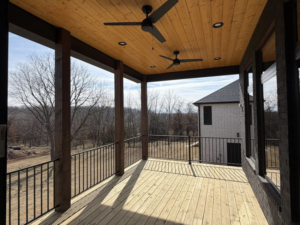 A newly constructed outdoor covered deck with ceiling fans by ELS Construction in Springfield, MO.