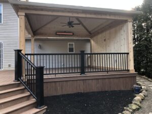 A newly constructed outdoor covered patio with a ceiling fan and heater by Inspired Renovation & Hardscape's in Lorain, OH.