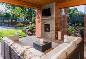 Outdoor covered patio with fireplace by American Home Improvements, LLC in Knoxville, TN