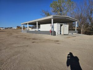 An outdoor covered storage area with shipping containers, constructed by M.M. Remodelers in Resaca, GA.