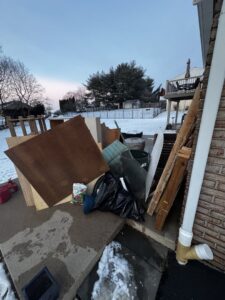 A pile of outdoor debris including wood, cardboard, and trash bags, ready for junk removal by Vatter Hauling Service in Lancaster, PA.