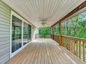 A spacious outdoor wooden deck with a newly installed ceiling fan by Gray Fox Enterprises in Roanoke, VA