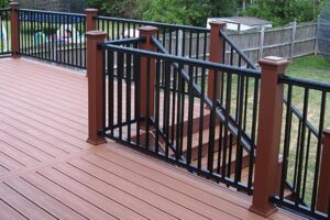 A newly built outdoor deck with brown composite planks and black metal railings by Pro Renovations Savannah, GA.