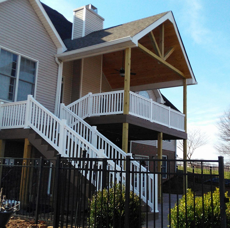 A newly constructed outdoor deck with stairs and a covered patio, built by Clayton's Remodeling And Home Services in Vero Beach, FL.
