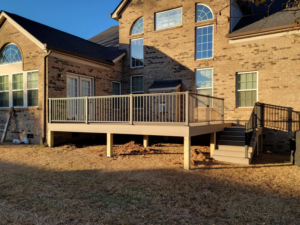 A spacious outdoor deck with stairs leading to the yard, built by AccampoBros Home Solutions in Greenville, SC.