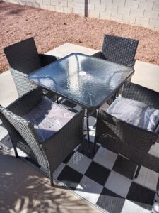 A newly assembled outdoor dining set with a glass-top table and four chairs, completed by Tech Handy-Las Vegas in North Las Vegas, NV.