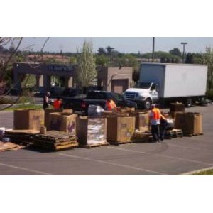 An outdoor e-waste collection event with a truck and staff in safety vests, organized by E-Waste Recovery Systems in Sacramento, CA.
