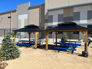 Two newly assembled outdoor gazebos with blue picnic tables, installed by Prospective 1, LLC in Sparks, NV.