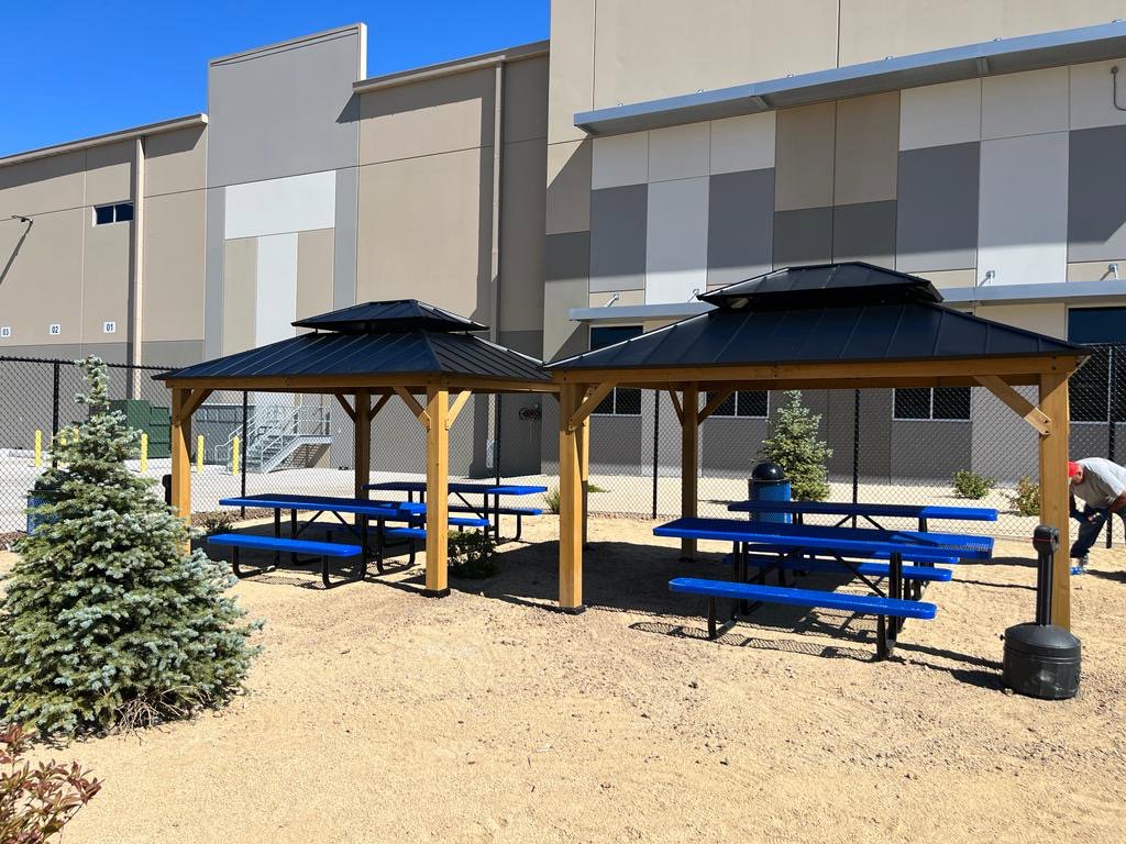 Two newly assembled outdoor gazebos with blue picnic tables, installed by Prospective 1, LLC in Sparks, NV.