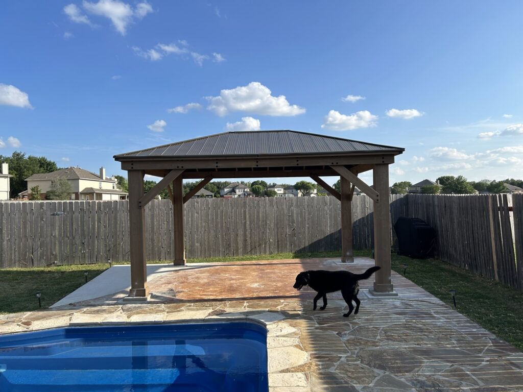 A newly installed outdoor gazebo next to a swimming pool, a project completed by Jez Enterprises in Aurora, CO.