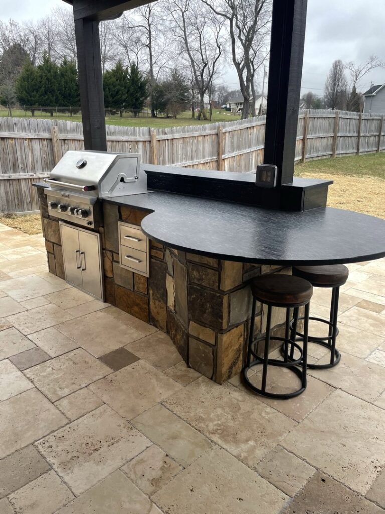 An outdoor grill and bar area with stone accents, perfect for entertaining, built by Technically Aesthetic General Contractors in Johnson City, TN.