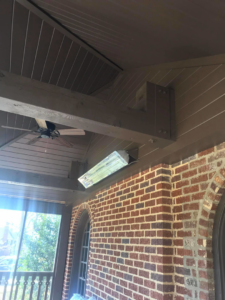 An outdoor heater and ceiling fan installed on a screened porch by Clarke Handyman Services in San Clemente, CA.