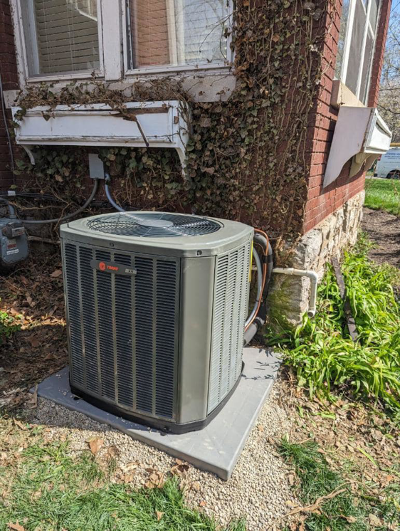 An outdoor HVAC unit installed next to a house by Stivers HVAC, providing service in Lexington, KY.