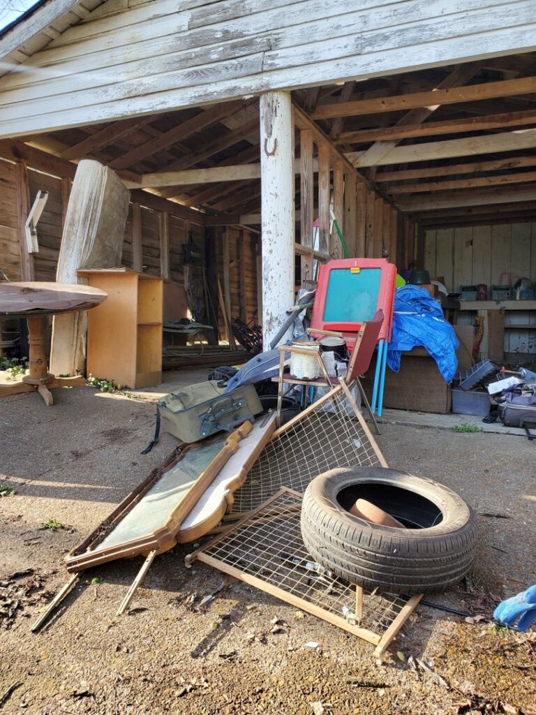 Various items of outdoor junk, including a tire and old furniture, awaiting removal by Sonny Day Junk Removal in Batesville, AR.