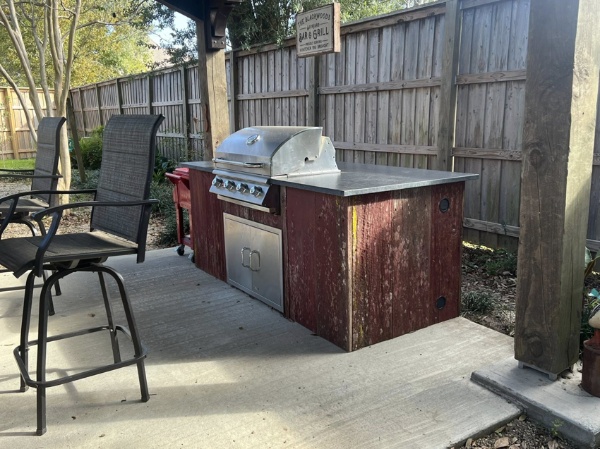A custom outdoor kitchen and grill station built by Ourso Renovations in Baton Rouge, LA