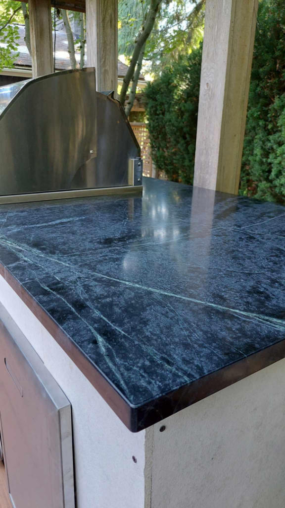 Close-up of a dark green marble-look outdoor kitchen countertop by Eagle Outdoor Living LLC in Freeland, WA.