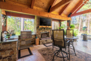 A custom outdoor kitchen and patio construction with a built-in grill and fireplace by All Star Construction, Inc. in Houston, TX.