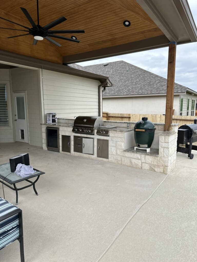 A newly constructed outdoor kitchen and patio area with built-in grill by PaRu Construction LLC in San Antonio, TX